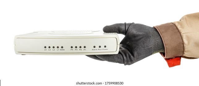 Man Hand In Black Protective Glove And Brown Uniform Holding VoIP Gateway Isolated On White Background