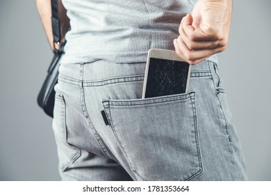 man hand broken phone on pocket  on grey background