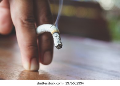Man hand with burning cigarette as penis in smoking cause sexual erectile dysfunction,  tobacco causes to Erectile dysfunction
