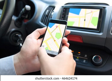 Man Hand In The Car Holding Phone With Navigation Map And On The Screen Multimedia System