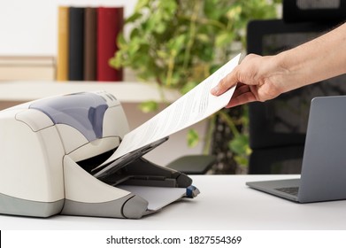 Man Hand Catching A Document From A Printer At Home.