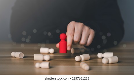 A man hand choosing red wooden figure. The concept of leaders for business success, Leadership, Personnel selection and competition. Job human resources for teamwork. Target customer. manager or CEO.