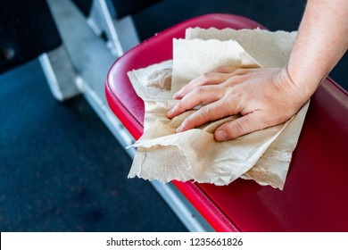 Man Hand Cleaning Workout Machine In Gym