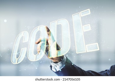 Man hand clicks on Code word hologram on blurred office background, artificial intelligence and neural networks concept. Multiexposure