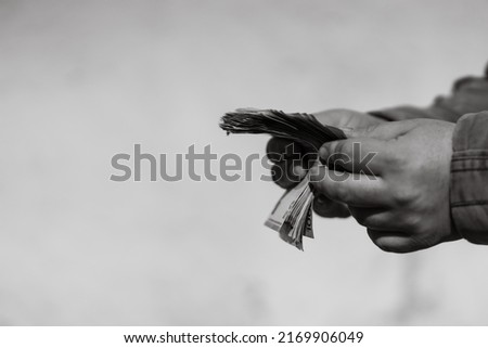 Man hand counting money for a bribe or tips. Holding EURO banknotes on a blurred background, EURO currency