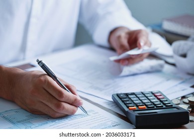 Man hand filling US tax form. tax form us business income office Financial document. Tax time.Tax concept. Close-up. - Shutterstock ID 2036033171