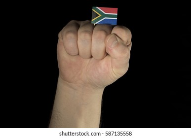 Man Hand Fist With South African Flag Isolated On Black Background