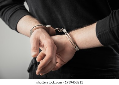 man hand handcuffs in back