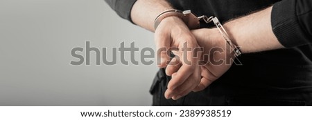 man hand handcuffs in back