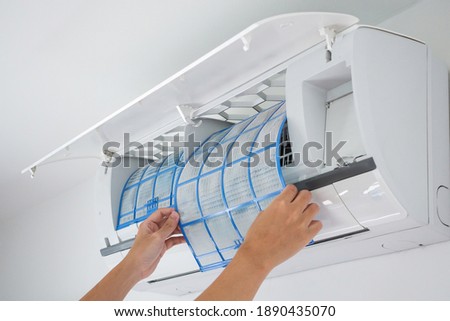 man hand hold air conditioner filter cleaning concept