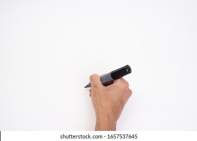 Man Hand Holding Black Magic Marker Pen Writing On White Background