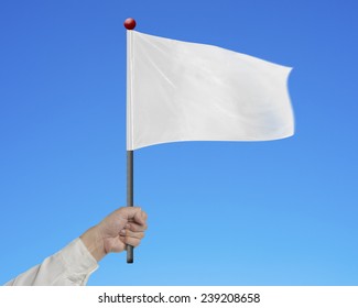 Man Hand Holding Blank White Flag Isolated On Blue Background