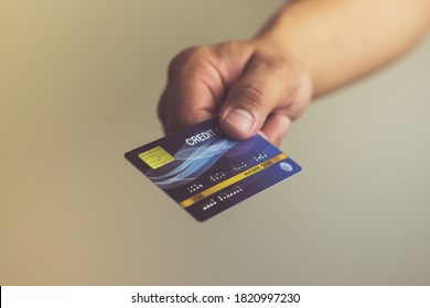 A Man Hand Holding Blue Credit Card, Financial Business And Online Marketing Concept