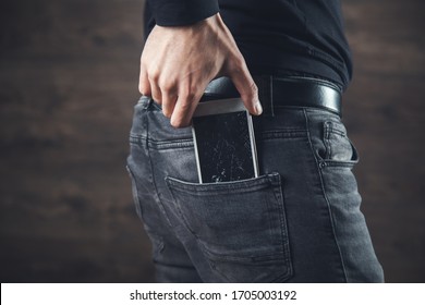 Man Hand Holding Broken Phone In Pocket