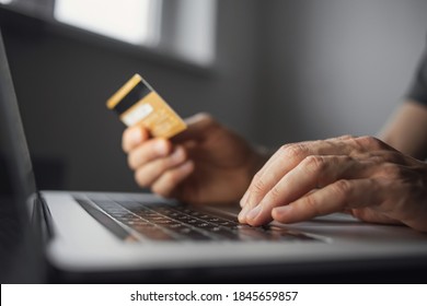 Man hand holding credit card and using laptop at home. Businessman or entrepreneur working in office. Online shopping, internet banking, store online, payment, spending money, e-commerce concept - Shutterstock ID 1845659857