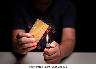 Man Hand Holding Credit Card And He Is Burning Credit Card Concept Of The Financial Impact Of Using Credit Cards.