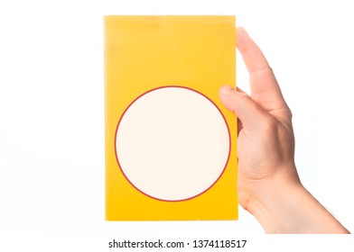 Man Hand Holding A Crime Novel Book With Blank Cover On White Background