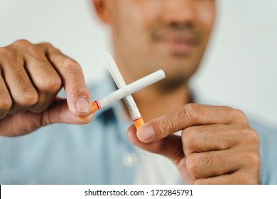 Man Hand Holding Crossed Cigarettes. Concept Quitting Smoking,World No Tobacco Day.