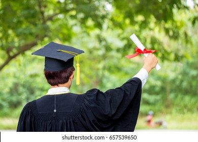 Man Hand Holding Diploma With A Red Ribbon Of Graduate Student.