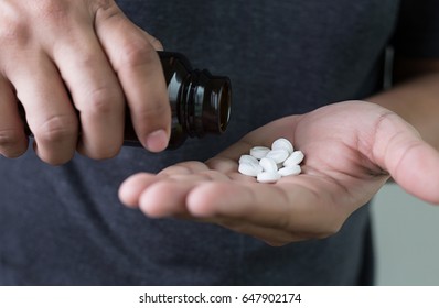 Man Hand Holding Frug Medicine Bottle On Herbal Supplement Pill,eating Healthy