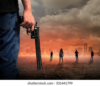 Man hand holding gun with zombie and burn city background