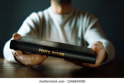 Man Hand Holding Holy Bible