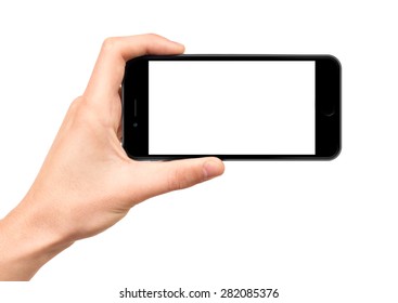 Man hand holding horizontal the black smartphone with blank screen, isolated on white background. - Shutterstock ID 282085376