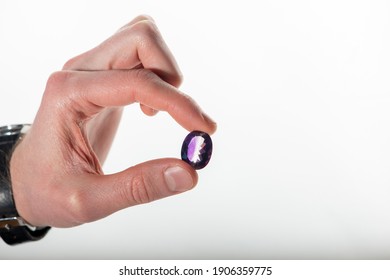 Man Hand Holding Large Polished Amethyst Gemstone.