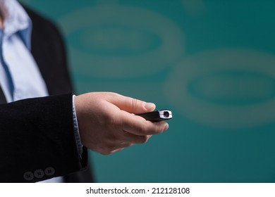 Man Hand Holding Laser Pointing. Man Standing With Laser Pointer On Green Background. 