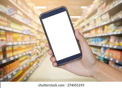 Man Hand Holding Mobile Smart Phone , Tablet,cellphone Over Blur Of  Backgrond With  Shopping Center Or Super Market Background.shopping Online.vintage Photo