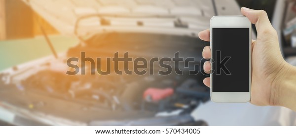 Man hand
holding mobile smart phone Contact Car repairing,Hand of car
technician auto mechanic with a wrench working in garage. service
in auto repair station.vintage tone,for
banner