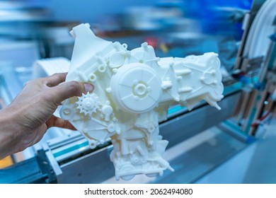 Man Hand Holding Model Of An Internal Combustion Engine Made Of Plastic On A 3d Printer