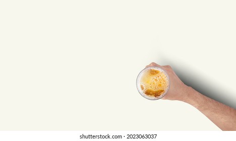 Man Hand Holding Mug Full Of Beer On White Background. Isolated Top Up View.