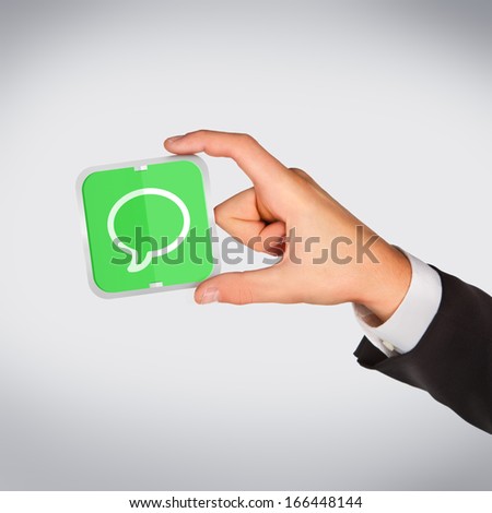 Man hand holding object (chat icon) High resolution