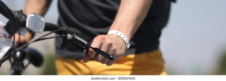 Man Hand Holding Onto Bicycle Steering Wheel