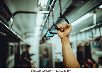 Man Hand Holding Onto A Subway Train Handle