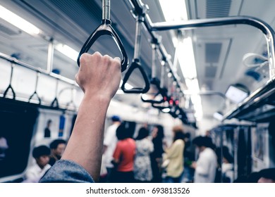 Man Hand Holding Onto A Subway Train Handle