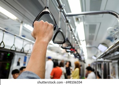 Man Hand Holding Onto A Subway Train Handle