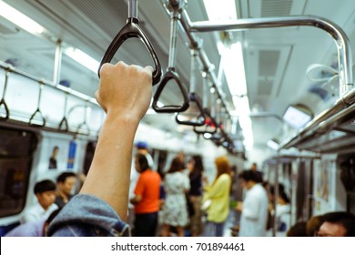 Man Hand Holding Onto A Subway Train Handle