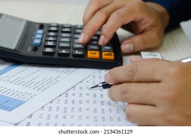 Man Hand Holding A Pen And A Calculator Making Financial Plans Tax And Business Investment.