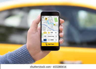 Man hand holding phone with app call taxi screen on background of yellow car