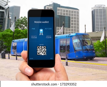 Man Hand Holding The Phone Touch With A Mobile Wallet And Train Ticket Against The Blue Train To The City