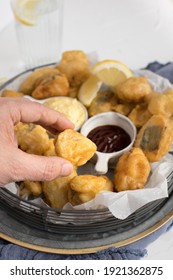 Man Hand Holding A Piece Of Tempura Hake Ready To Spread It With Curry Sauce.