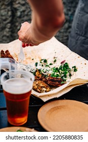 Man Hand Holding Plastic Fork With Meat And Sause Outdoor