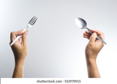 Man Hand Holding A Silver Fork And Spoon On White Background