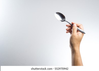 Man Hand Holding A Silver Spoon On White Background