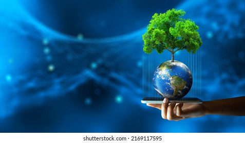 Man Hand Holding Smartphone With Technology Economic. Tree Growing On Earth And Wireframe Background. Green Computing, Green IT, Csr, And IT Ethics Concept. Elements Furnished By NASA.