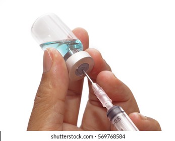 Man hand holding syringe and blue medicine vial. prepare for injection , isolated on white background - Shutterstock ID 569768584