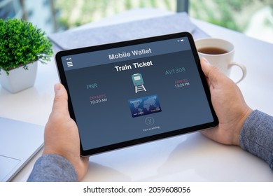 Man hand holding tablet computer with app pay Train Ticket service on the screen.