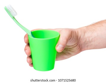 Man Hand Holding Toothbrush Isolated On White Background. New Tooth Brush In Hand - Dental Care.